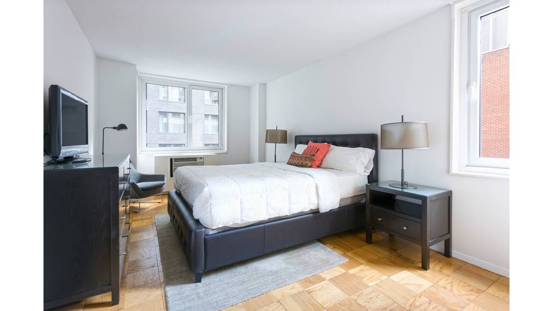 Expansive split two bedroom two bathroom apartment with windowed bathrooms and a PRIVATE BALCONY located in a full service luxury building in Midtown West.