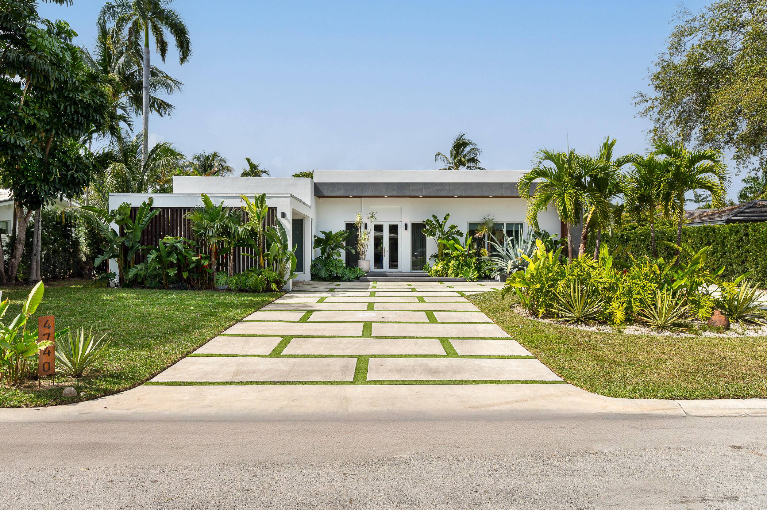 Step inside of this tropical modern oasis in the prestigious gated community of Bay Point.