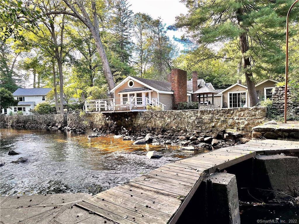 Wonderful cottage directly on the Rippowam River with amazing wrap around deck extending over water.