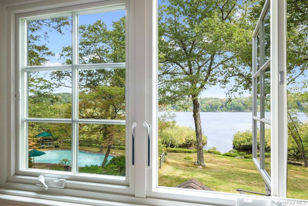 Rare lakefront privacy in this charming 1940's vintage home with lakeside pool and almost 3 acres of flat, usable land.