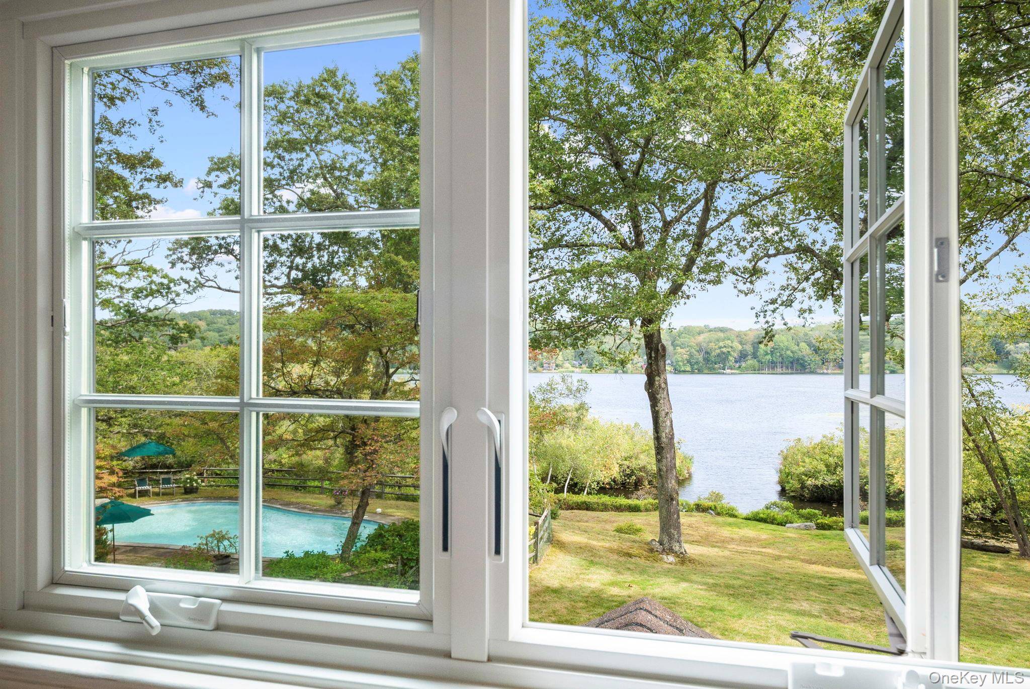 Rare lakefront privacy in this charming 1940's vintage home with lakeside pool and almost 3 acres of flat, usable land.