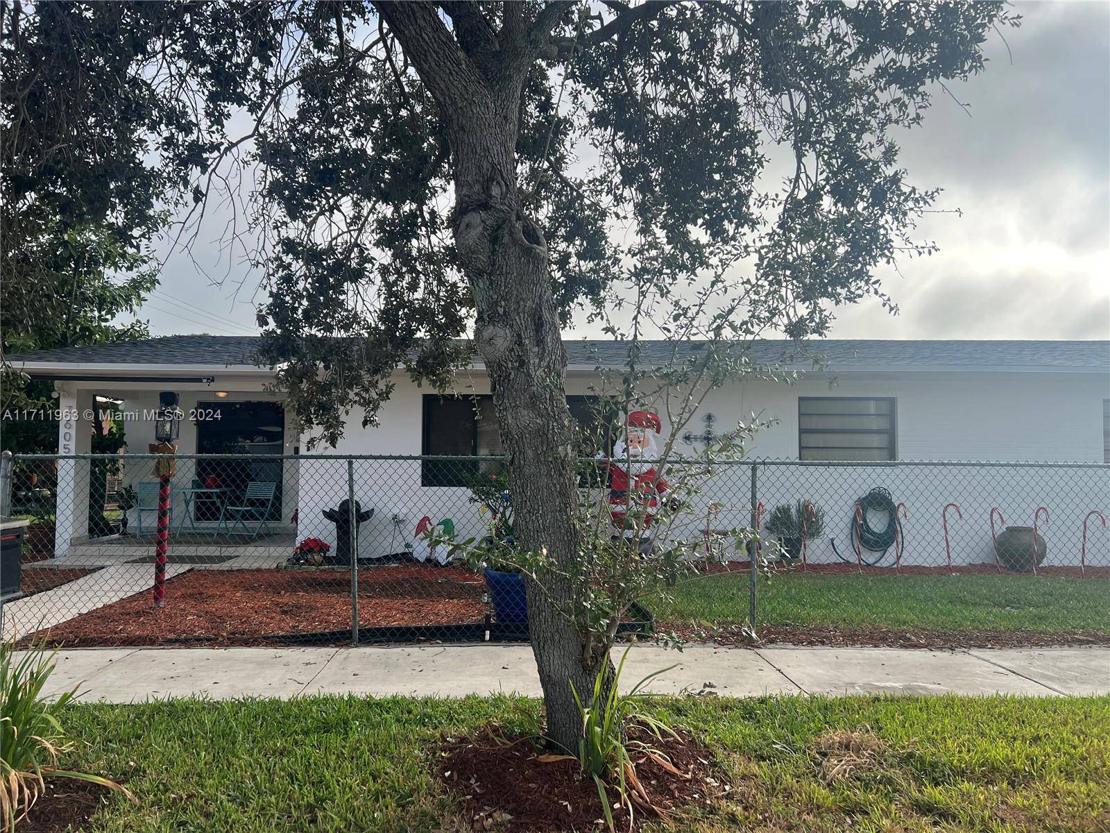 The home in the Miami Lakes area has four bedrooms, two baths, and IN LAW quarters.