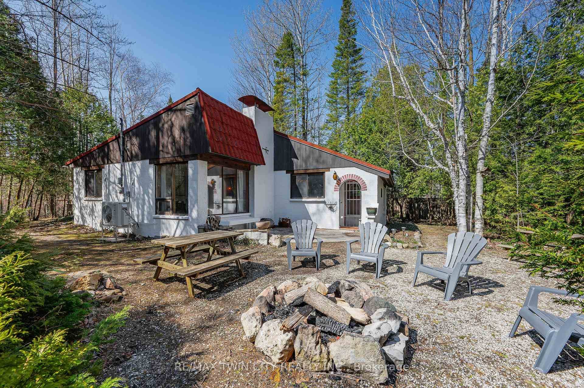 Welcome to 178 Brophy's Lane a charming four season bungalow tucked away on a private, tree lined half acre lot in The Blue Mountains.