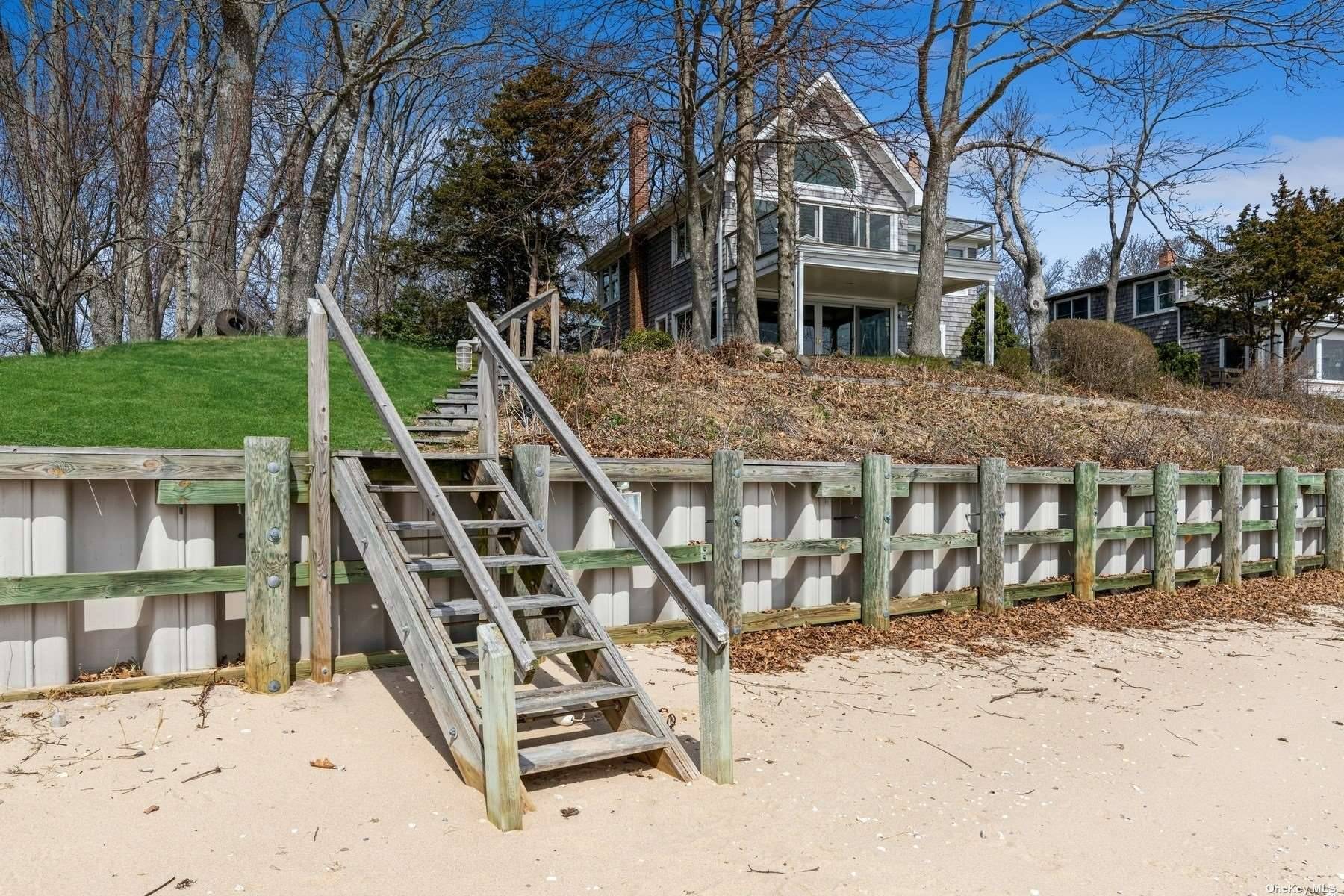 Cape Cod Style Cedar Shingle House situated on edge of low bluff.