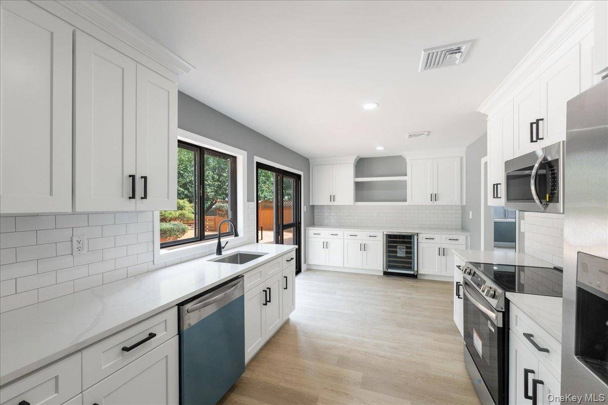 Welcome to this charming ranch at 5 Folsom Lane in Coram, where classic style meets modern convenience.