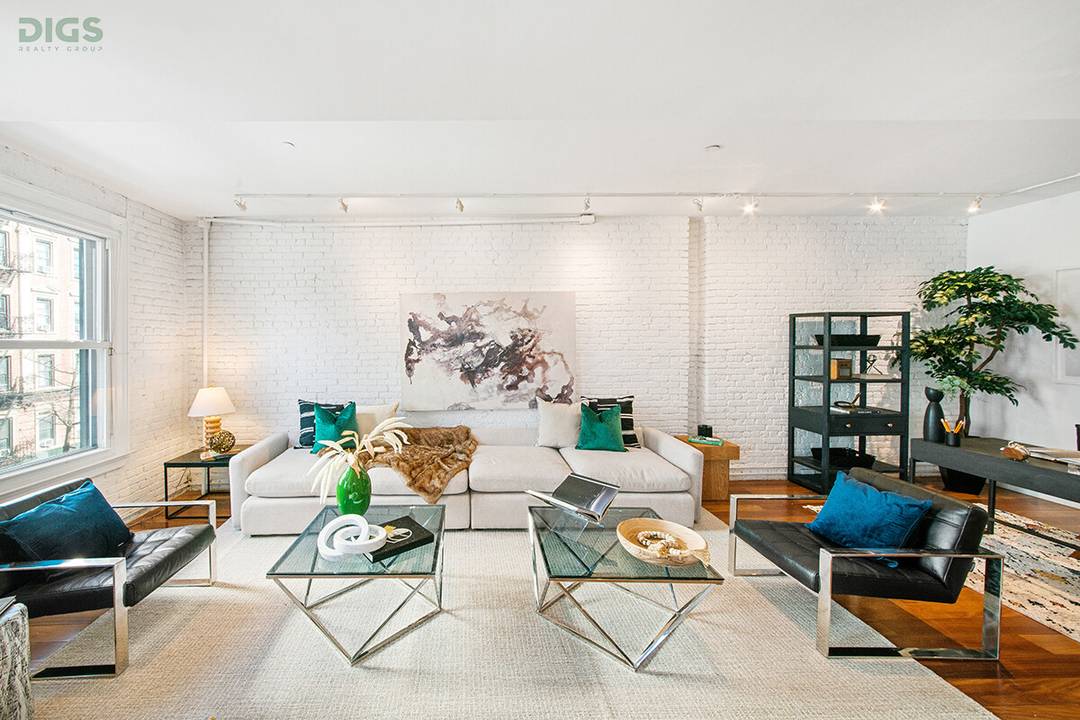 Grand, sun drenched, and rich in character, this classic floor through loft with central air conditioning sits in the heart of SoHo at Spring Street and 6th Avenue.