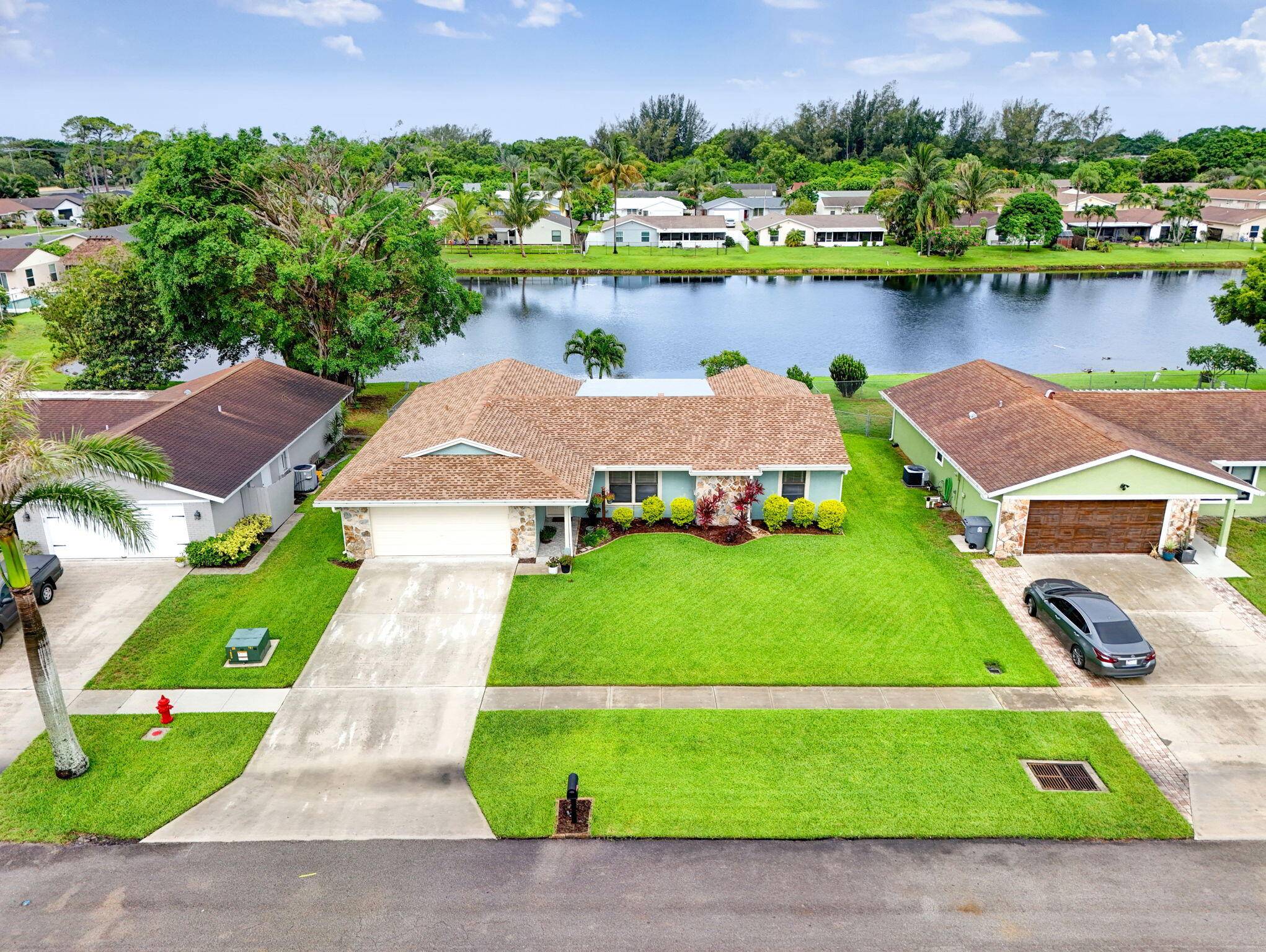 Large 4 bedroom with a 2 car garage, fully fenced lot with irrigation, lovely water view with paver patio, and December 2024 roof.