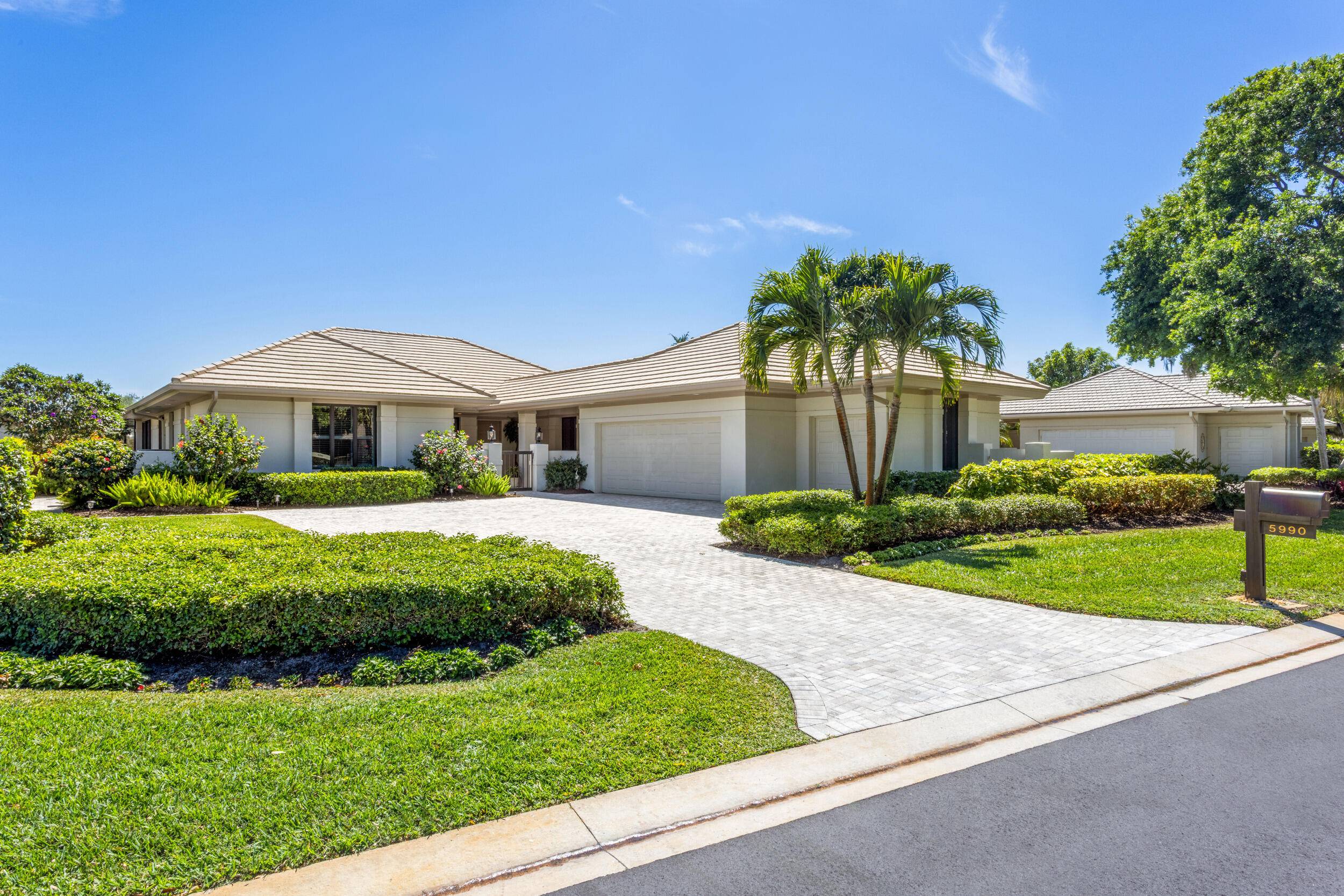 Welcome to 5990 SE Oakmont Place, a stunning 3 bedroom, 3 bathroom home overlooking Hole 2 of the Gold Course in the prestigious Mariner Sands Country Club.