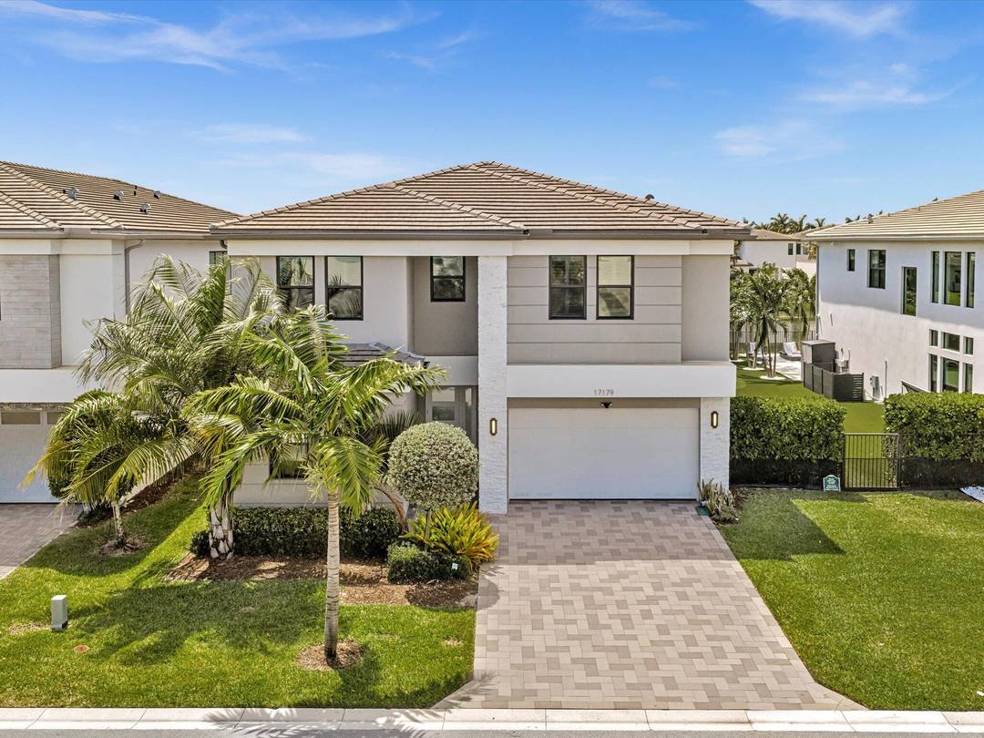 Located steps from the clubhouse, this lakefront pool home is filled with custom finishes and includes the furniture.