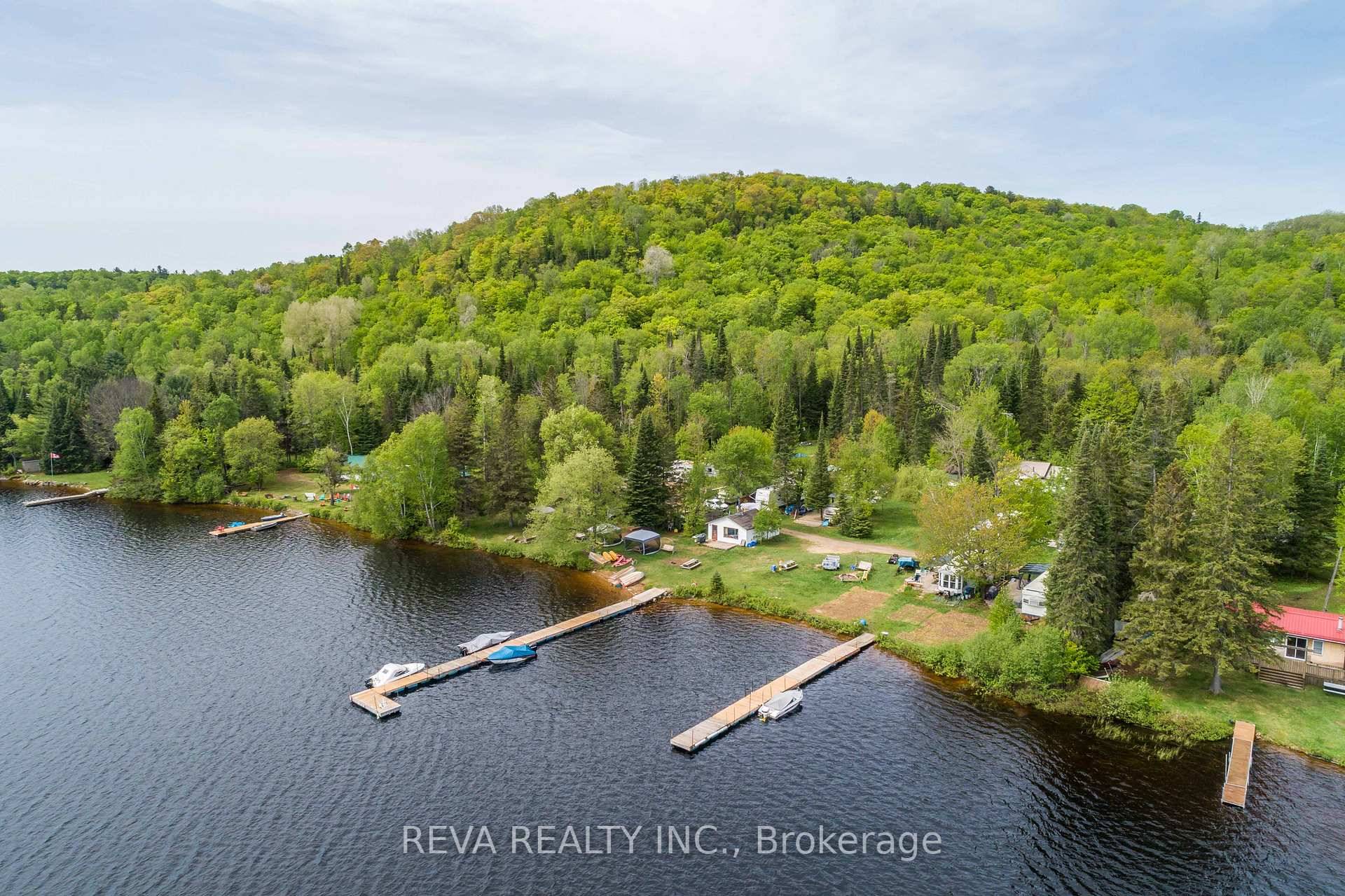 Baptiste Lake Opportunity 300 feet of South facing shoreline with two docks, twelve approved trailer sites with water, septic, and electricity hook ups, three lakeside cabins and a cottage residence ...