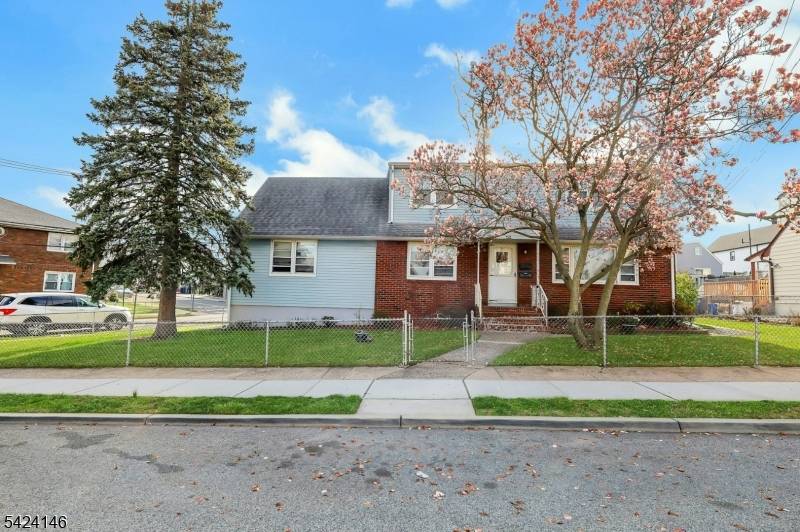 Expanded two family on a corner lot with parking for 7 vehicles.