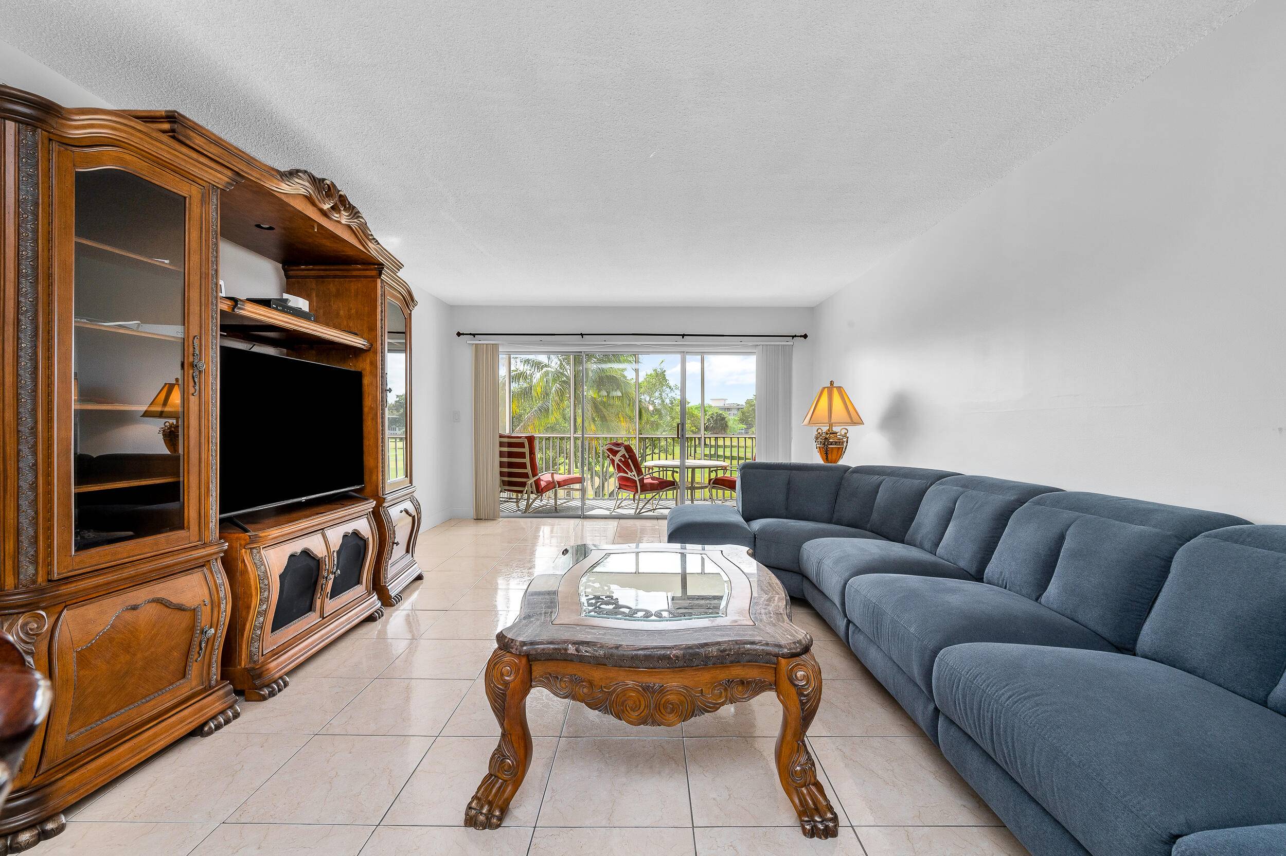 Spacious 2BR 2BA condo in the heart of Palm Aire Country Club with a screened balcony offering peaceful golf course views and beautiful morning light.