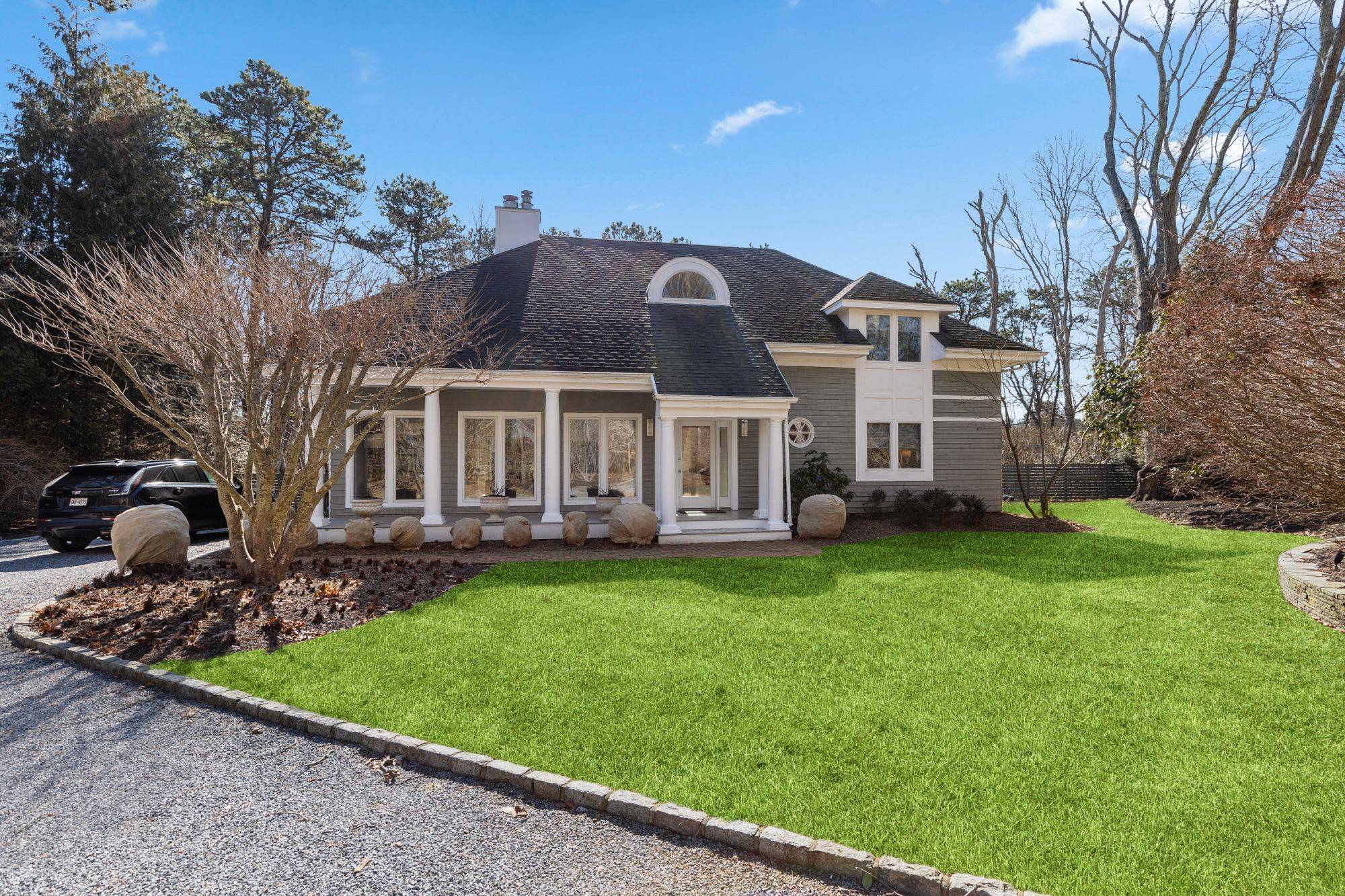 This Contemporary has a Gated Drive on 1 acre of beautifully landscaped grounds located just 2 miles from East Hampton Village.