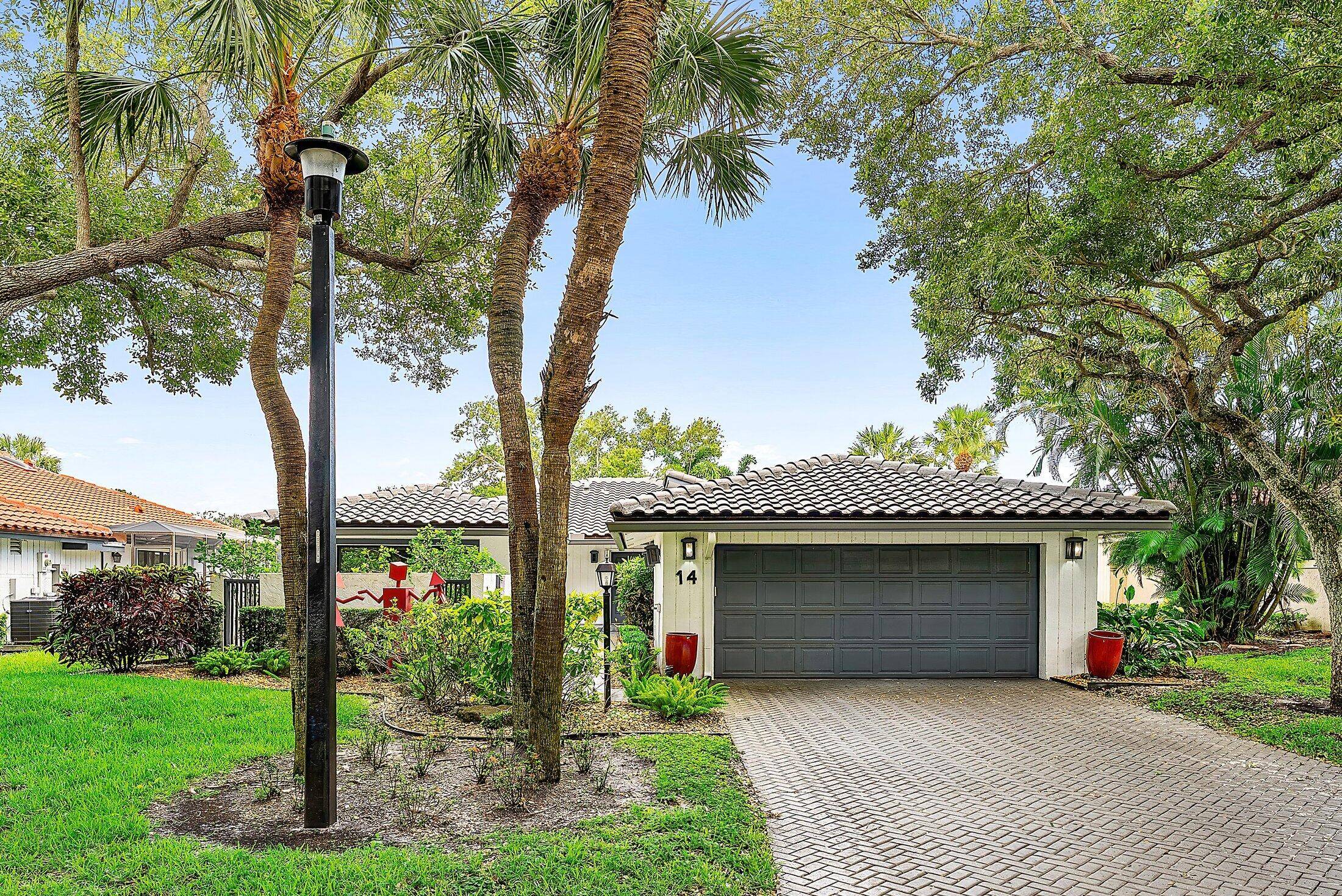 Nestled in The Oaks at Hunters Run Country Club, this exceptional mid century modern style home offers 2 spacious bedrooms plus a den, with 2.