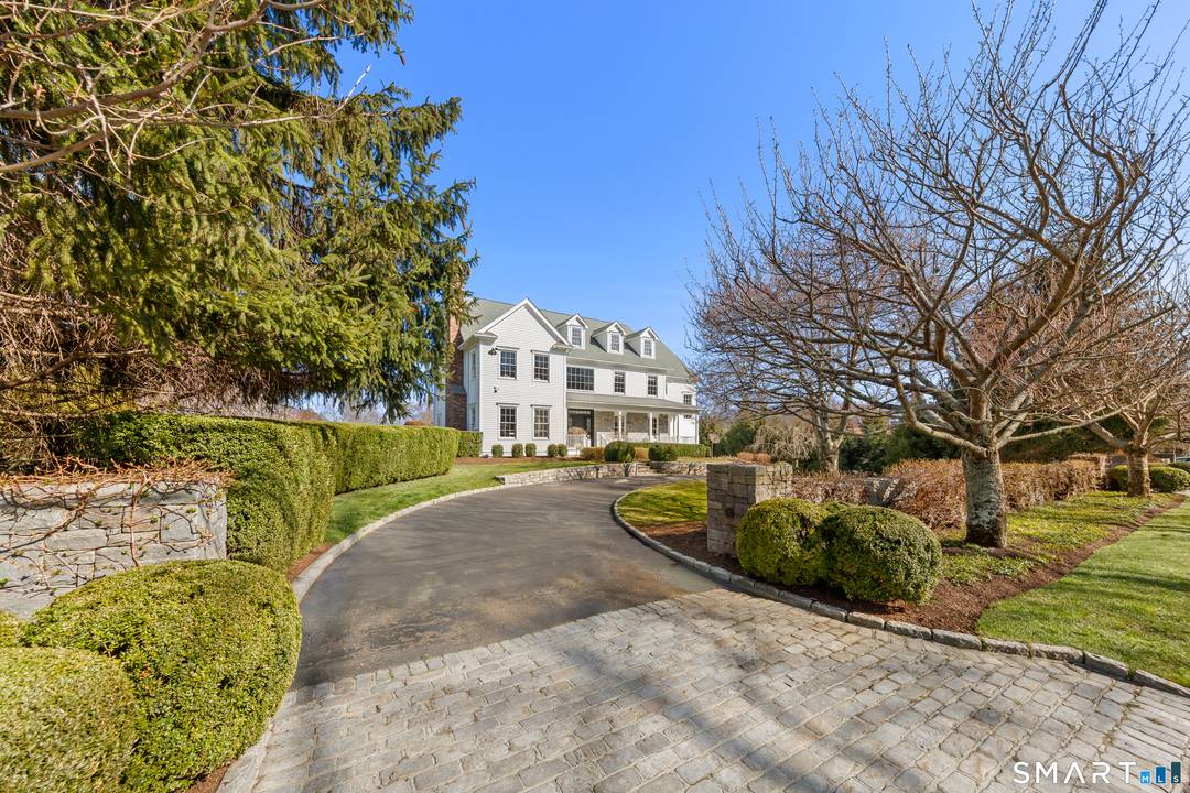 Beautifully sited in prestigious Greens Farms this timeless 5 BR, 6BA clapboard and stone Colonial offers stunning architecture resort like privacy just moments from train, town beaches.