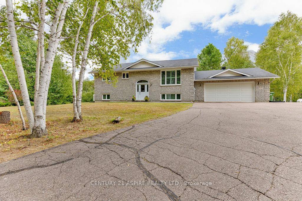 Welcome to this solid stone home nestled on a private and beautifully treed 1.