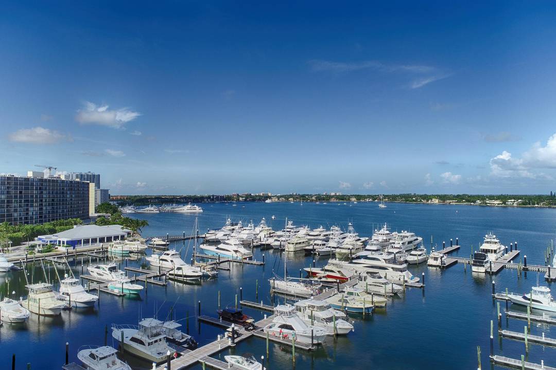 Wake up to sweeping views of the Intracoastal, Old Port Cove Marina, and the Atlantic Ocean from every room of this beautifully updated 2 bedroom, 2.