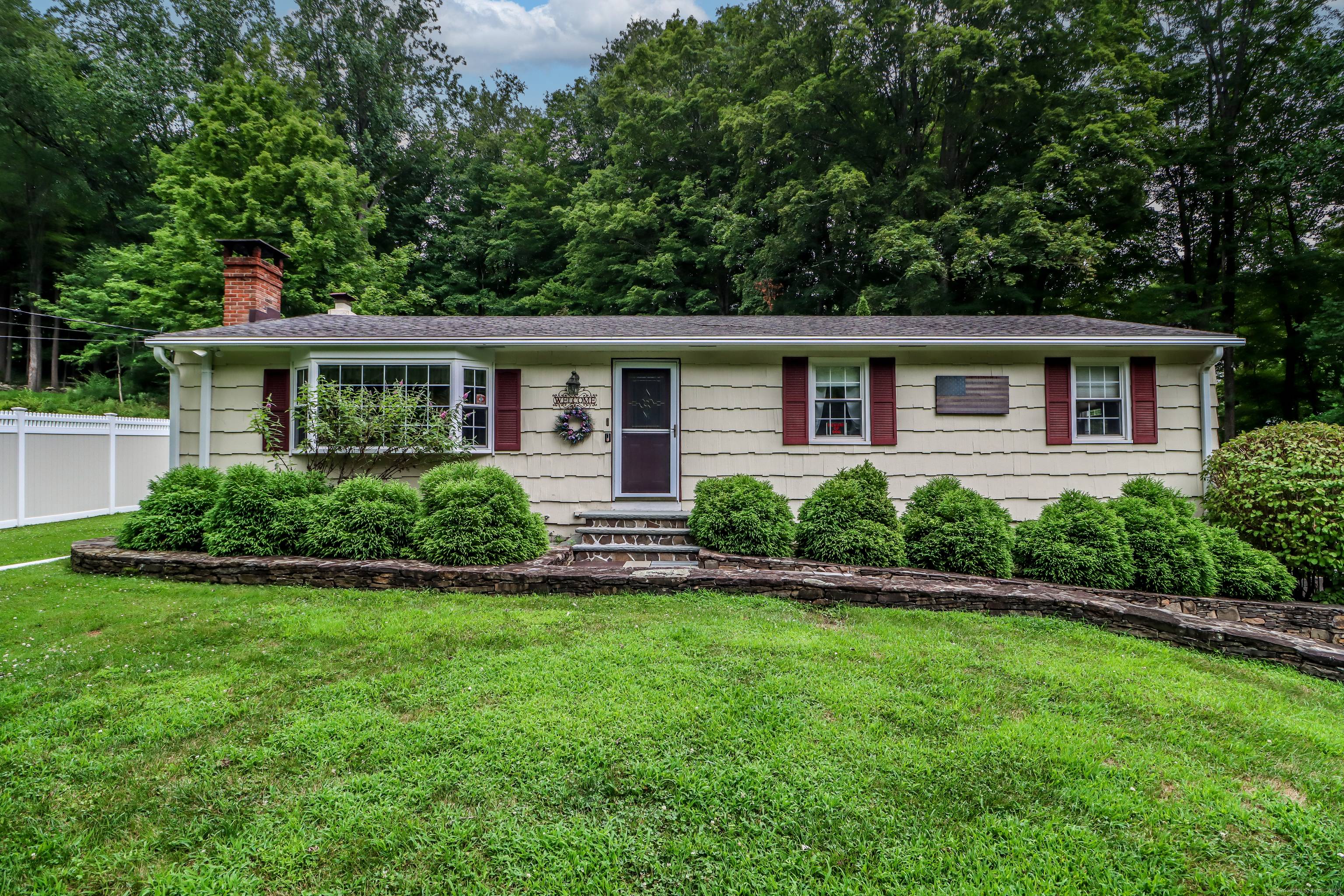 Tucked against a backdrop of lush woods, this appealing Ranch is the perfect blend of comfort natural beauty.