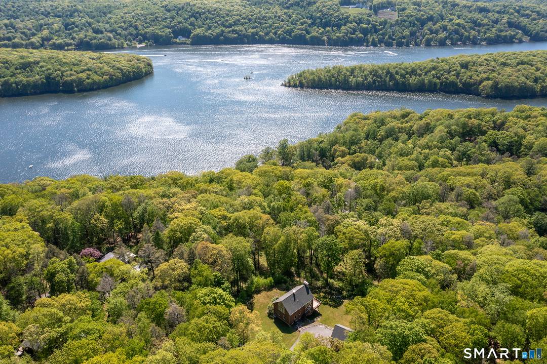 The Lake Experience ! Candlewood Lake Estates, a private gated community on Lake Candlewood hosts this 1998 built 3 bedroom, 2 bath contemporary with 2 dramatic stone, floor storage ceiling ...