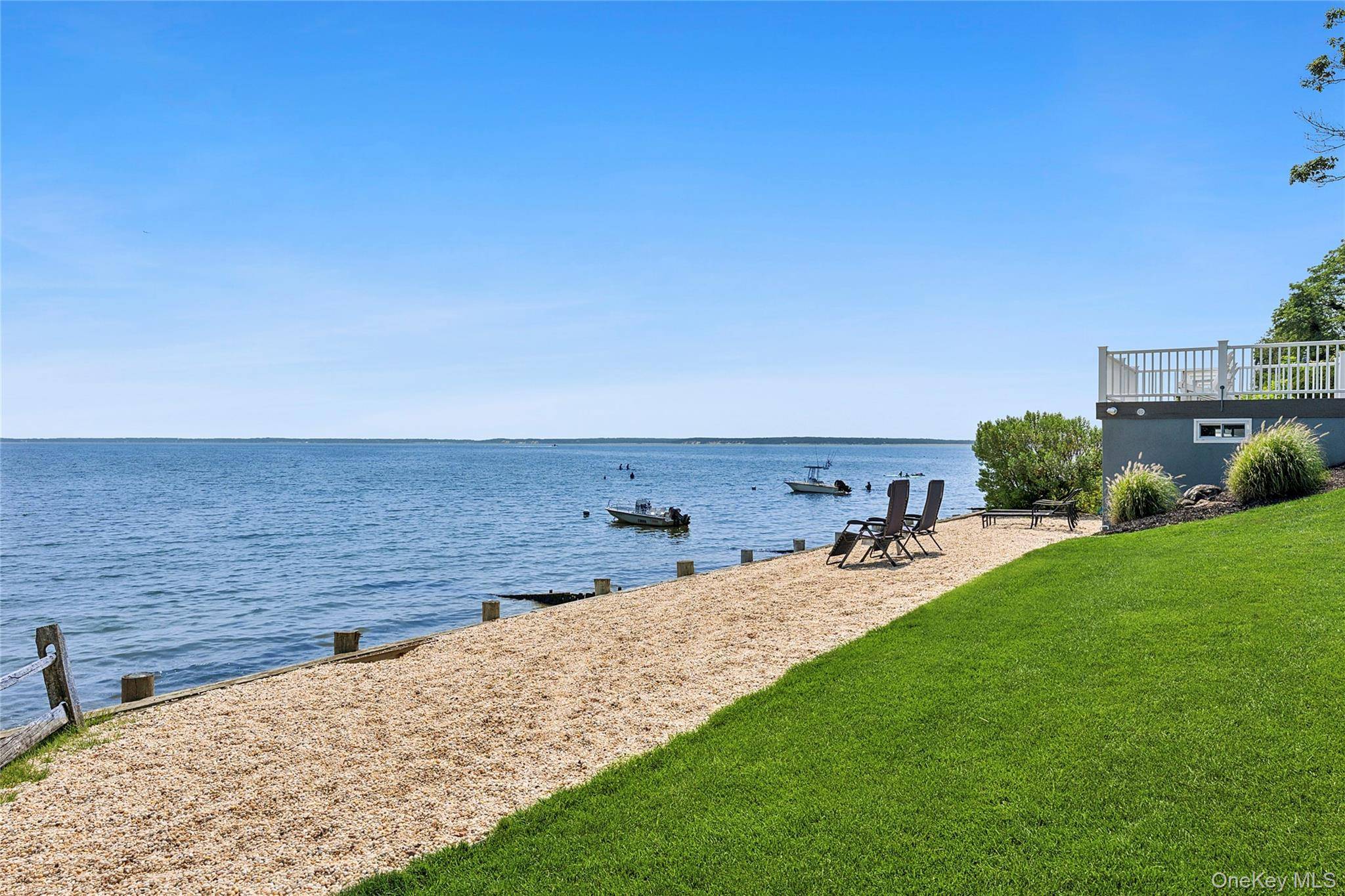 This stunning waterfront residence features over 100 feet of private beach and embodies the essence of coastal living.