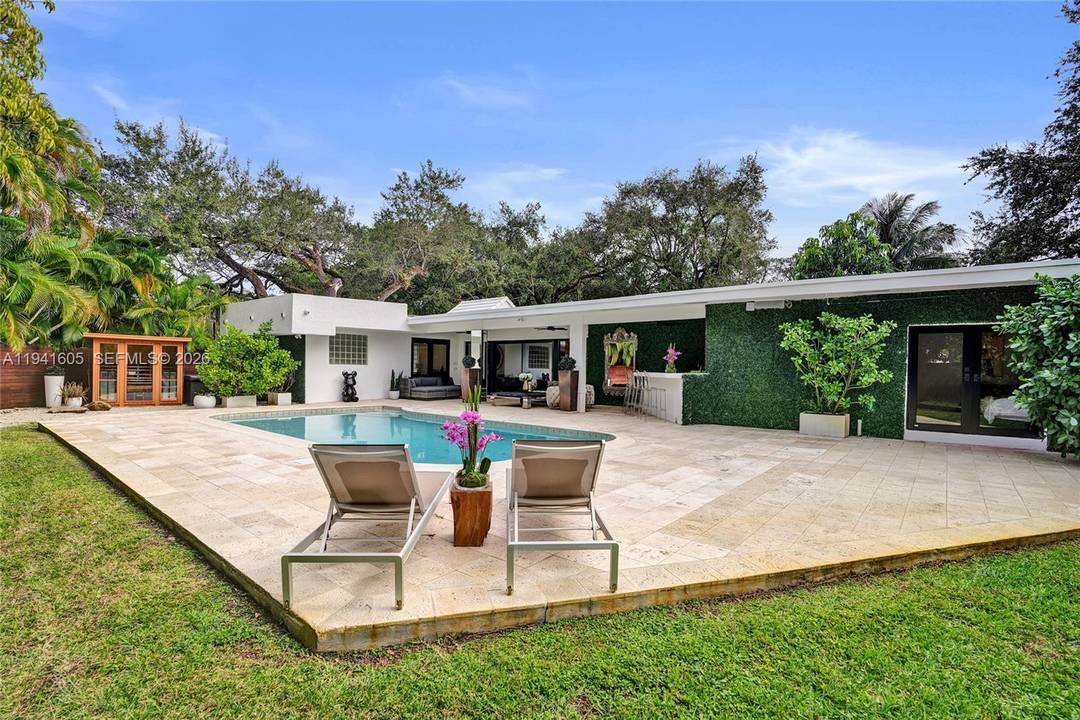 This private residential oasis offers 5 bedrooms, a den, and 4.