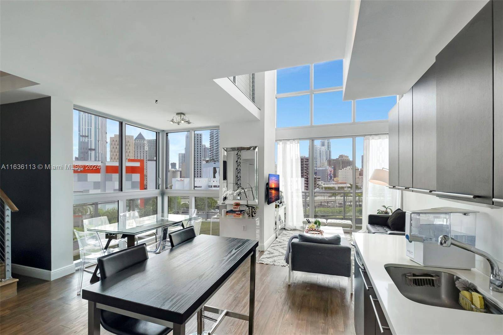 Rarely available corner townhouse type condo at The Ivy, with floor to ceiling windows that offer panoramic views of the Brickell skyline.
