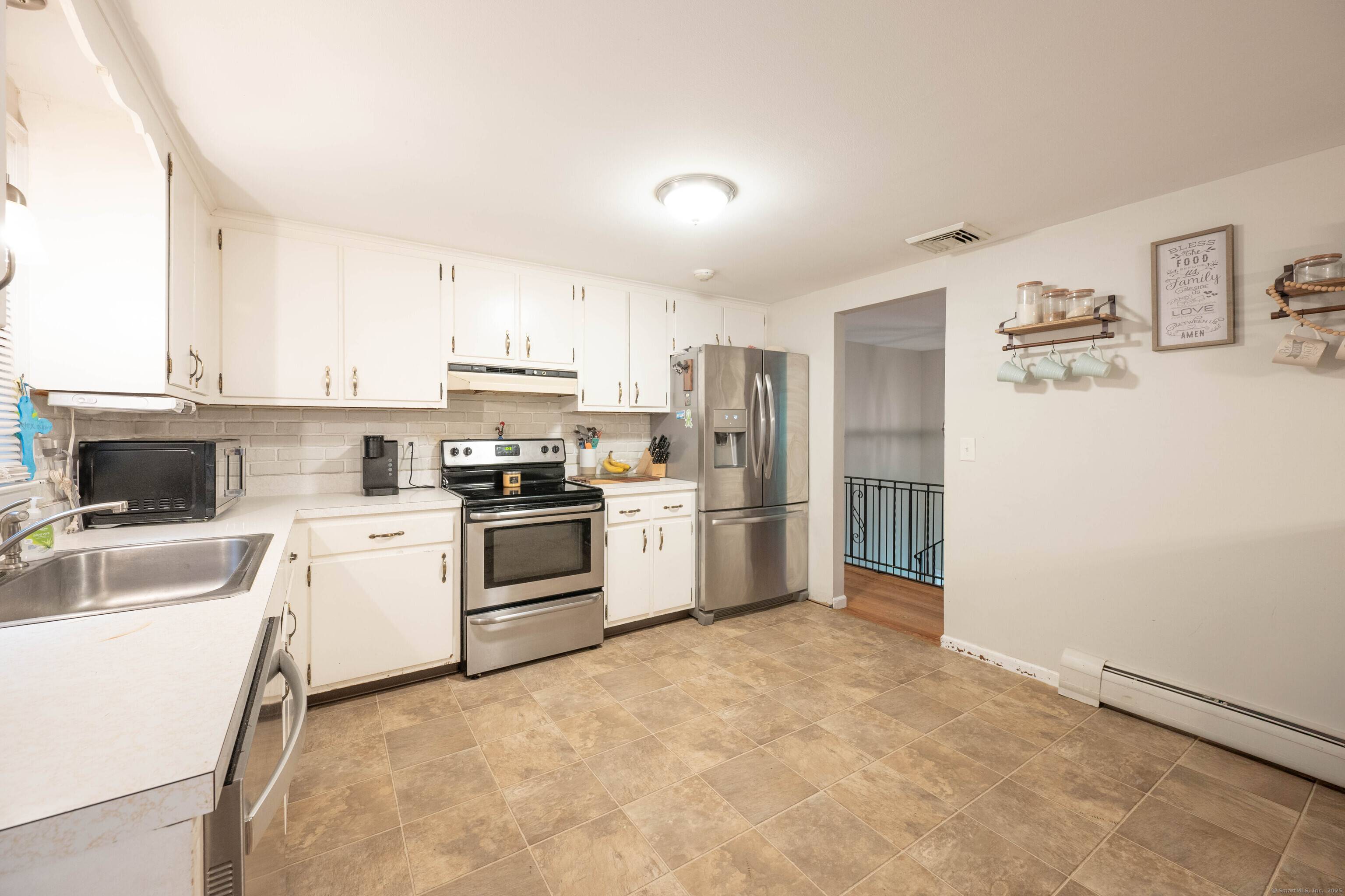 Expansive High Ranch on a secluded lot in a superb commute location !