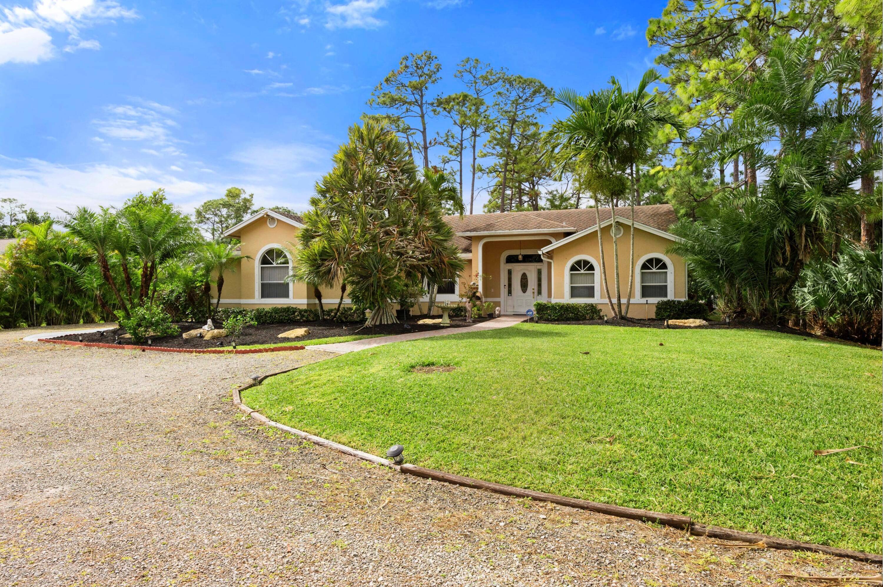 Florida Paradise ! Corner lot with three driveways and three gates for easy access.