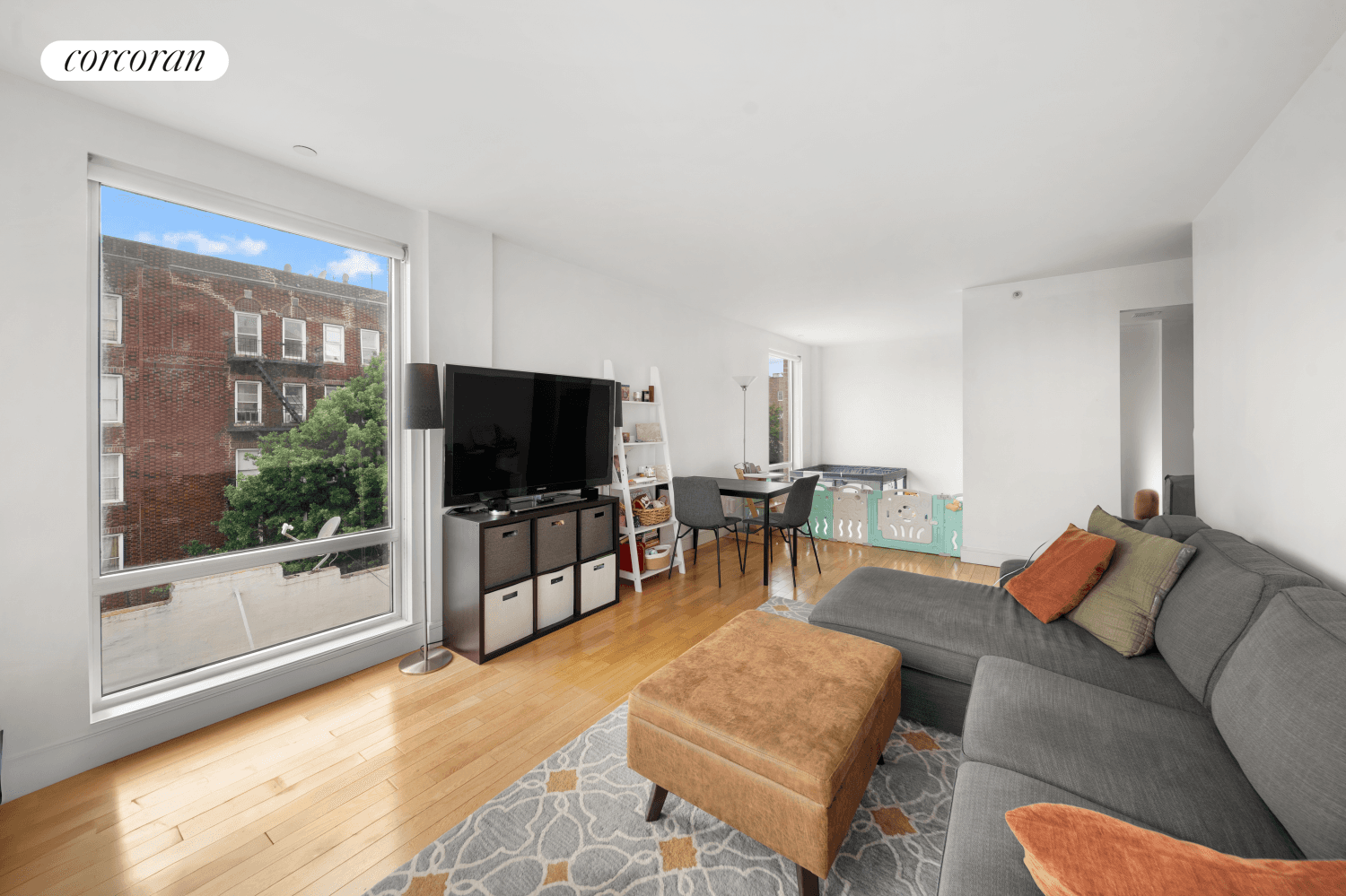 A deeded parking space with an electric charger and a private storage space are included.