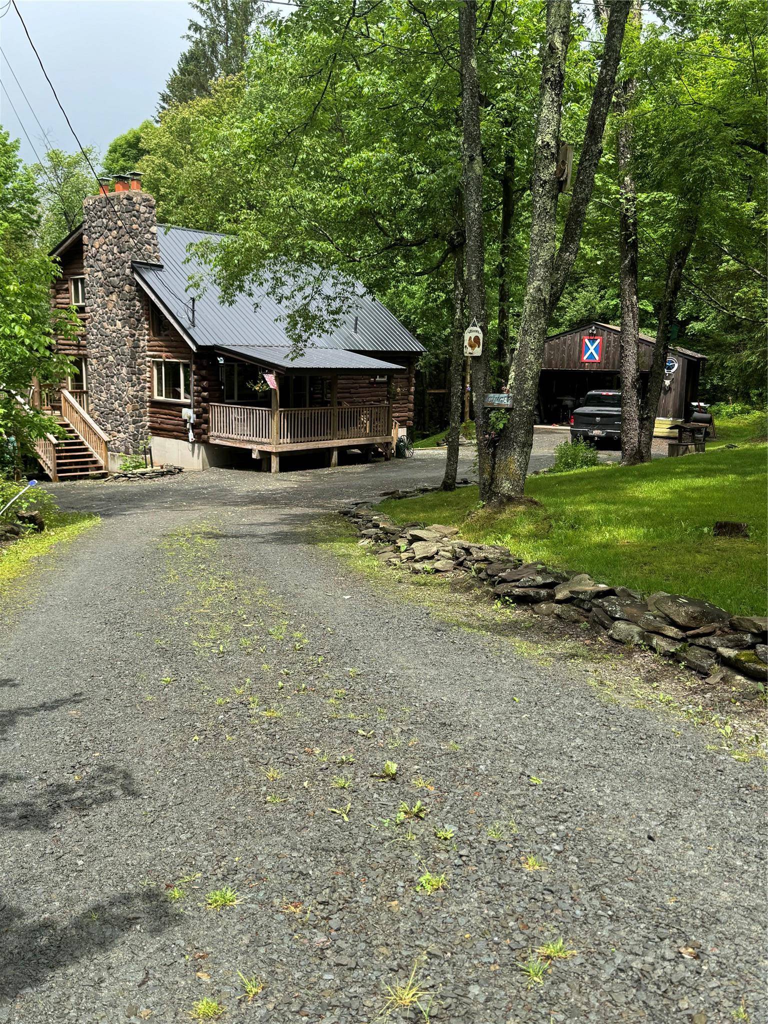 Escape the hustle and bustle of city life with this serene and secluded cabin, perfectly nestled in the woods at the end of a quiet dead end road.