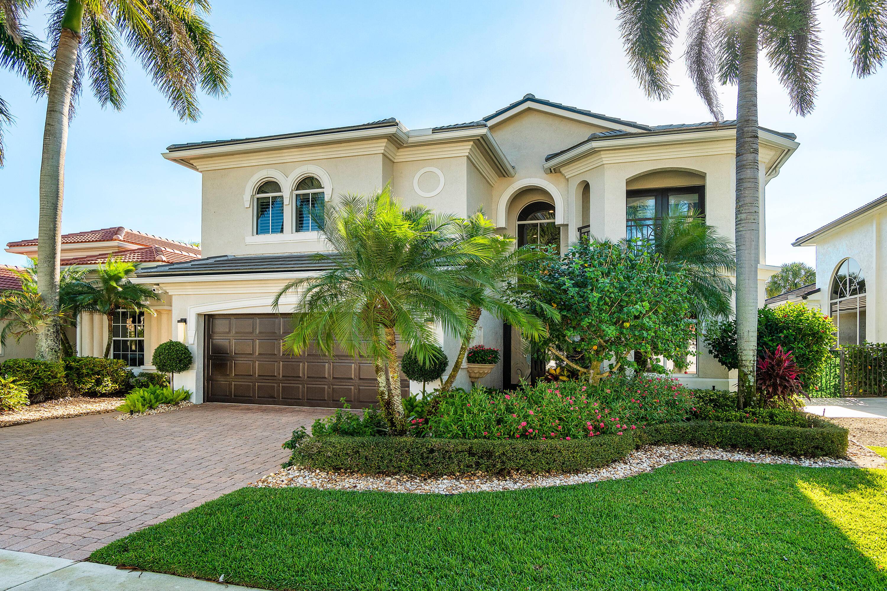 Nestled within one of South Florida's most coveted addresses, this extensively renovated lakefront residence at Mizner Country Club offers everything you could want.