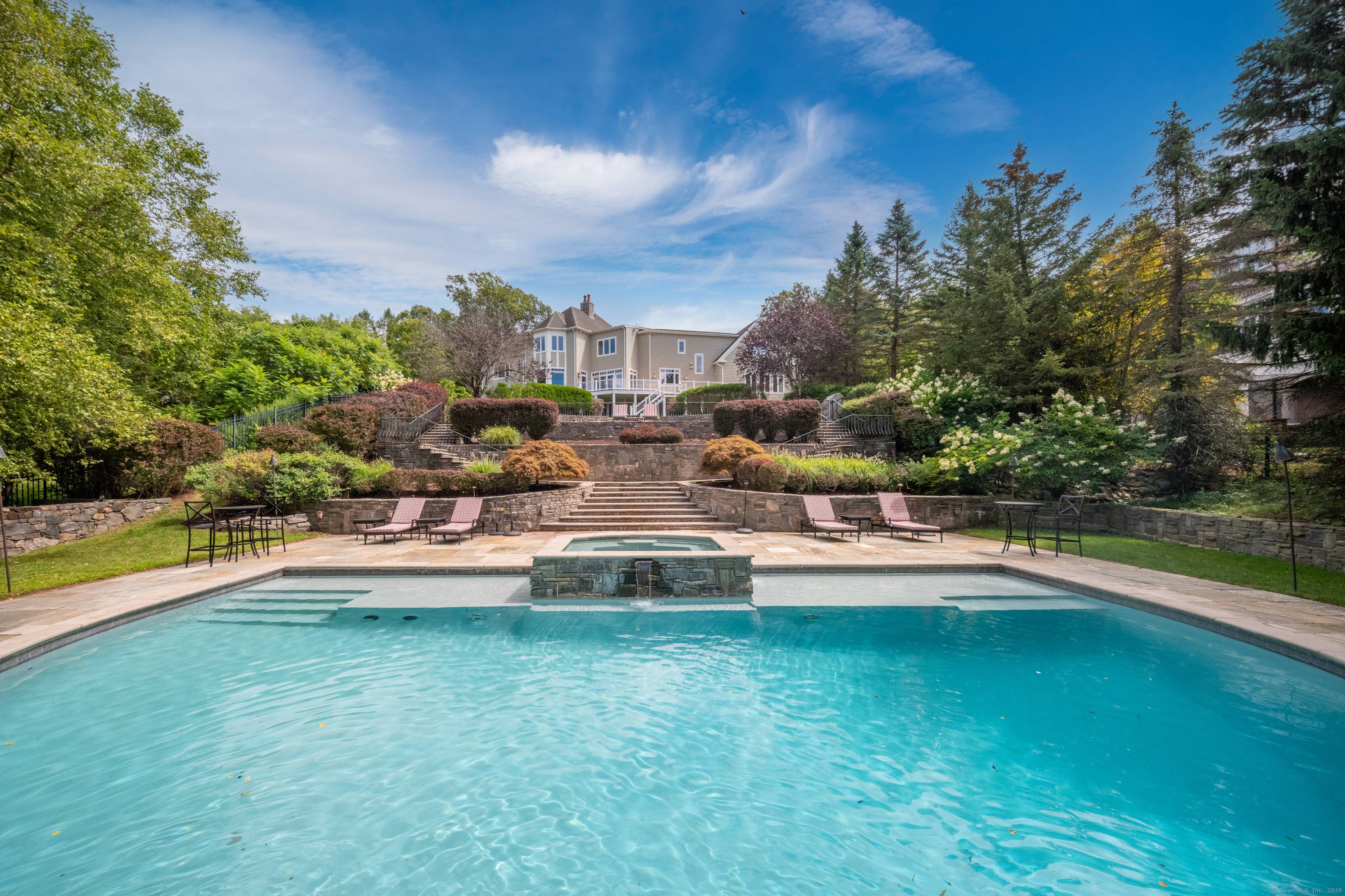 Breathtaking westerly views from this remarkable Stone Shingle style home privately set in a coveted east side enclave of distinguished homes.