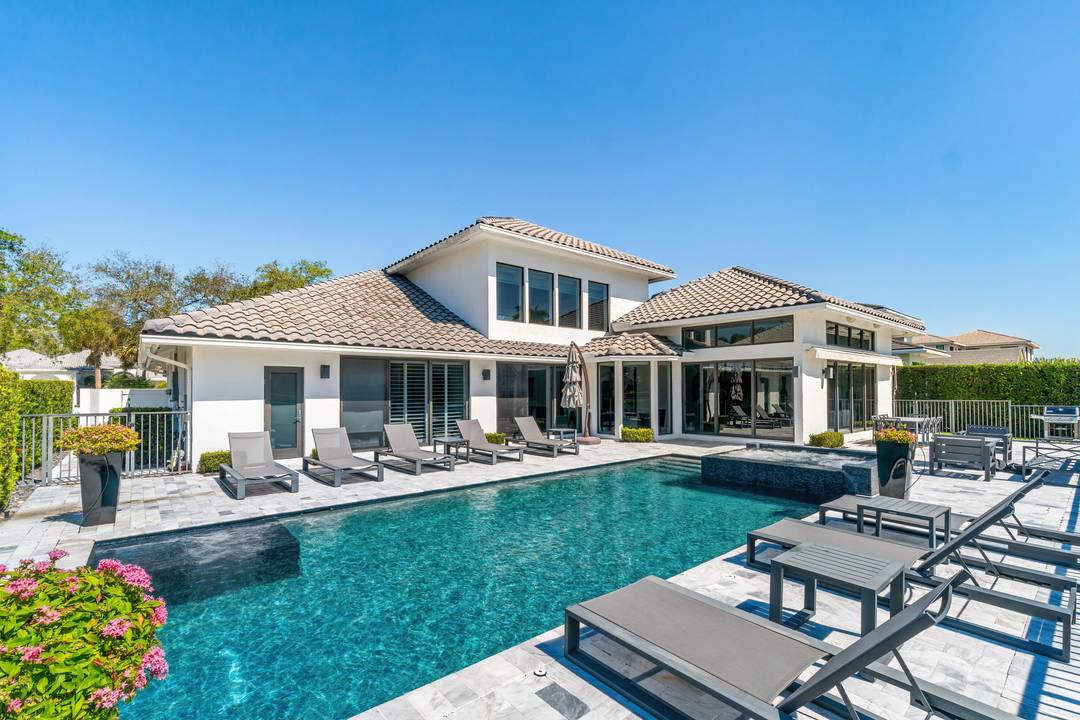 Experience refined luxury in this fully custom, renovated residence located in the exclusive Hamptons of Woodfield Country Club.
