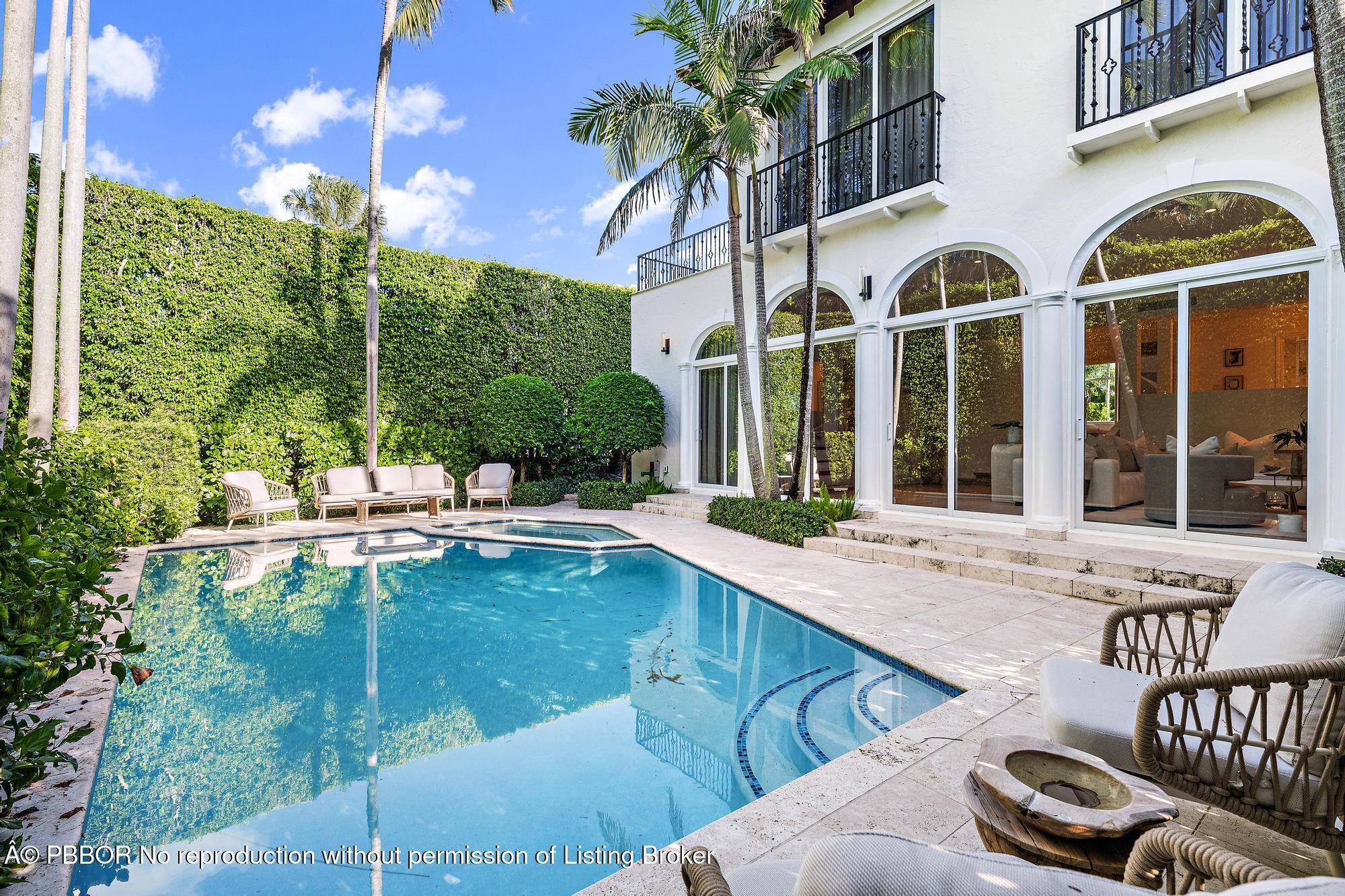 Featuring a rare CLAY TENNIS COURT and sunsets over an OLYMPIC SIZE LAP POOL on the Intracoastal, 245 Everglade Ave, a 3 BR 3.