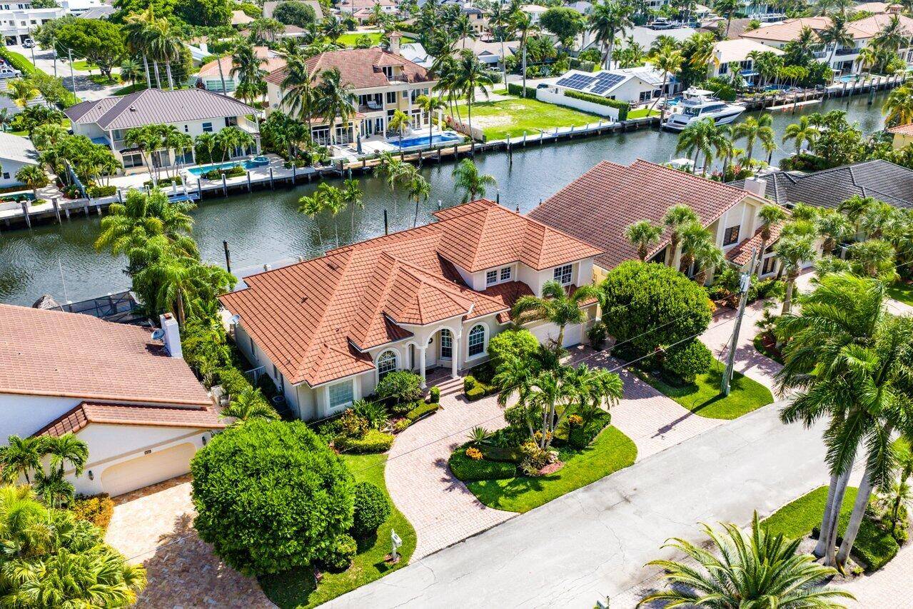 Welcome to 923 Hyacinth Dr where coastal elegance meets premier waterfront living in Delray Beach's Tropic Isle.