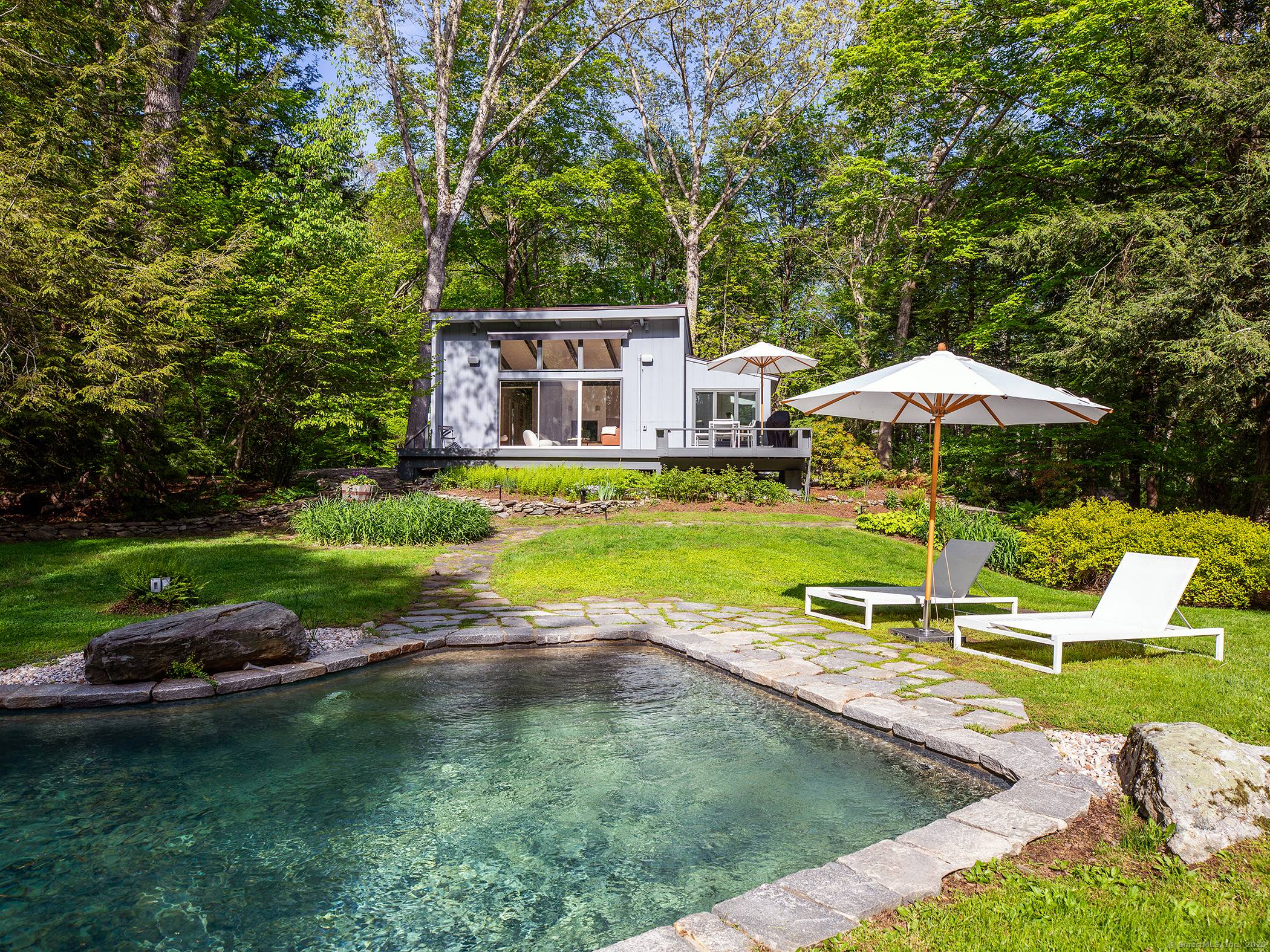 Step into timeless style and serene privacy with this beautifully maintained 1966 mid century modern home.