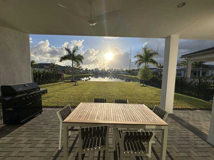 Rare opportunity to purchase a Premium Polynesian Model on the best lakefront lot in Lotus Palm.