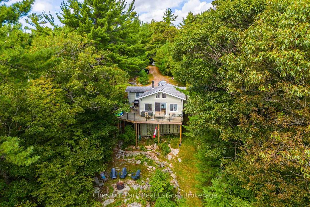 Tucked along a private, tree lined shoreline, this lakefront retreat makes an unforgettable first impression sweeping lake views greet you the moment you step through the front door.