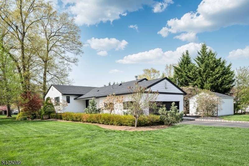 Exceptional home showcasing a striking porcelain walkway that creates a refined first impression.