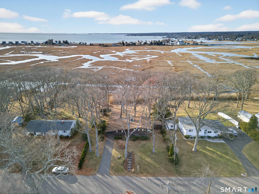 Direct waterfront property on a private lot at 33 Briarwood Drive with expansive marsh and tidal channel views.