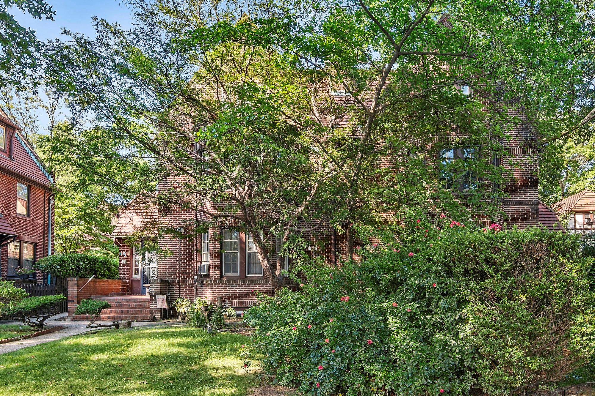 Traditional Brick home on a tree lined street in Forest Hills Gardens.