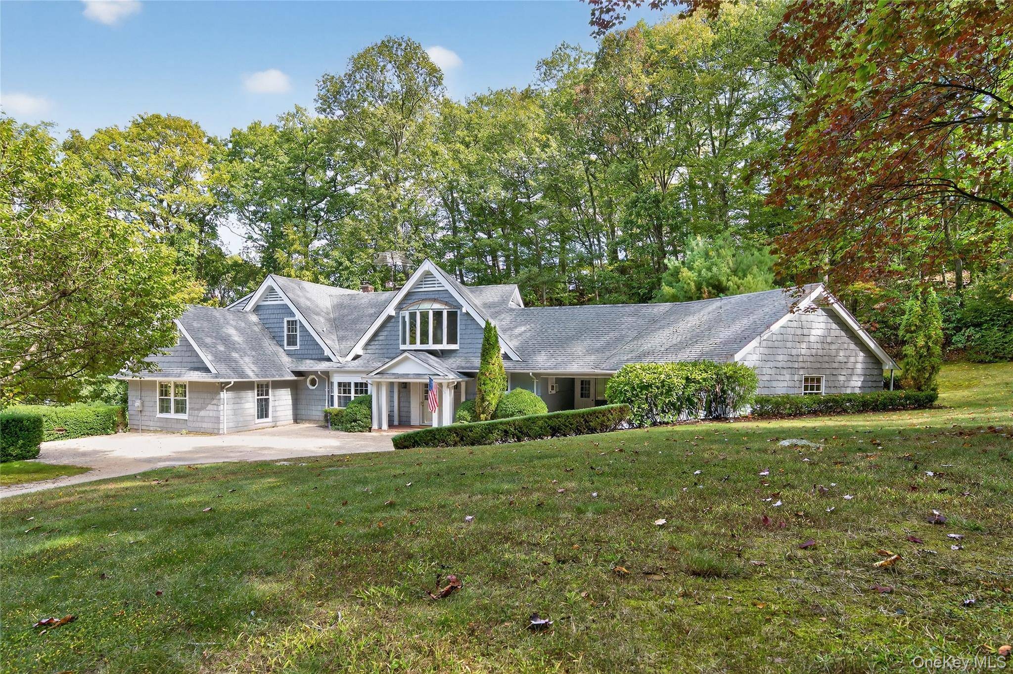 Charming cottage style home in Laurel Hollow offering a serene water view and Laurel Hollow beach access.