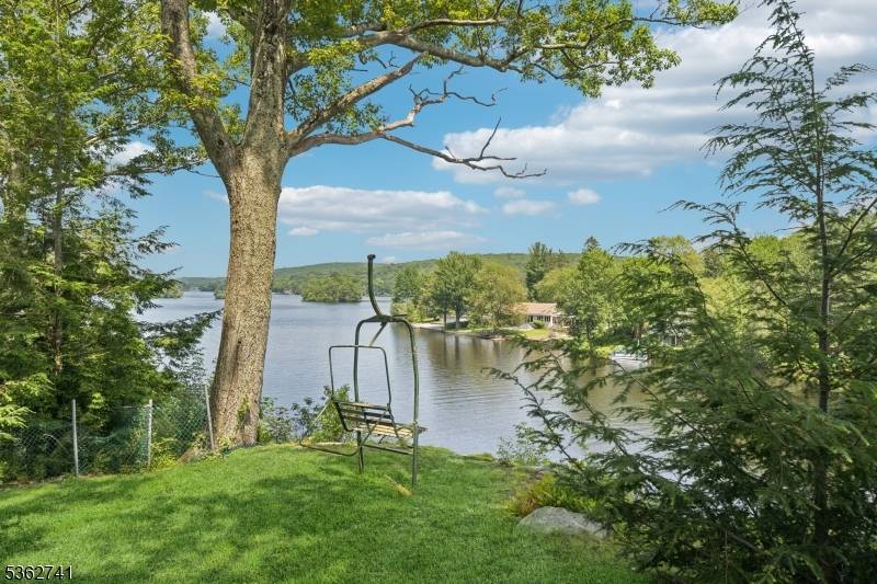 Contemporary lakefront living with unmatched views this home is sitting pretty perched high above Upper Greenwood Lake, where breathtaking panoramic views privacy await.