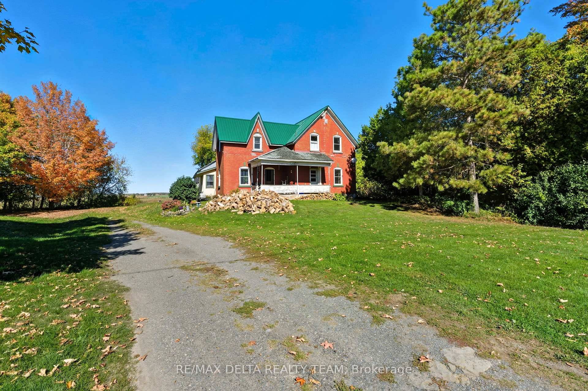 Experience the warmth and character of country living in this red brick century home, set on a private 0.