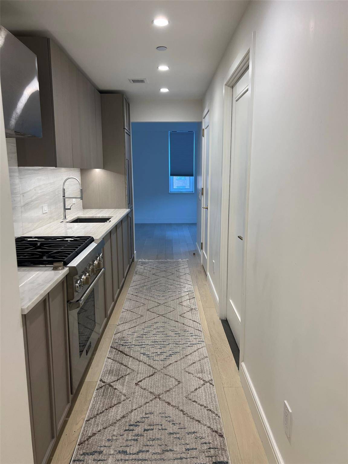 This elegant studio residence combines modern luxury with practical features, showcasing a corner living area bathed in natural light from floor to ceiling sound tempered windows facing North and East.