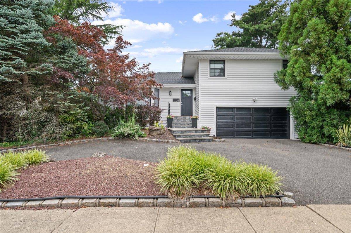 Welcome home to 47 Winthrop Road, a beautifully updated split level home located mid block in the Woodbury Hills section of Plainview.