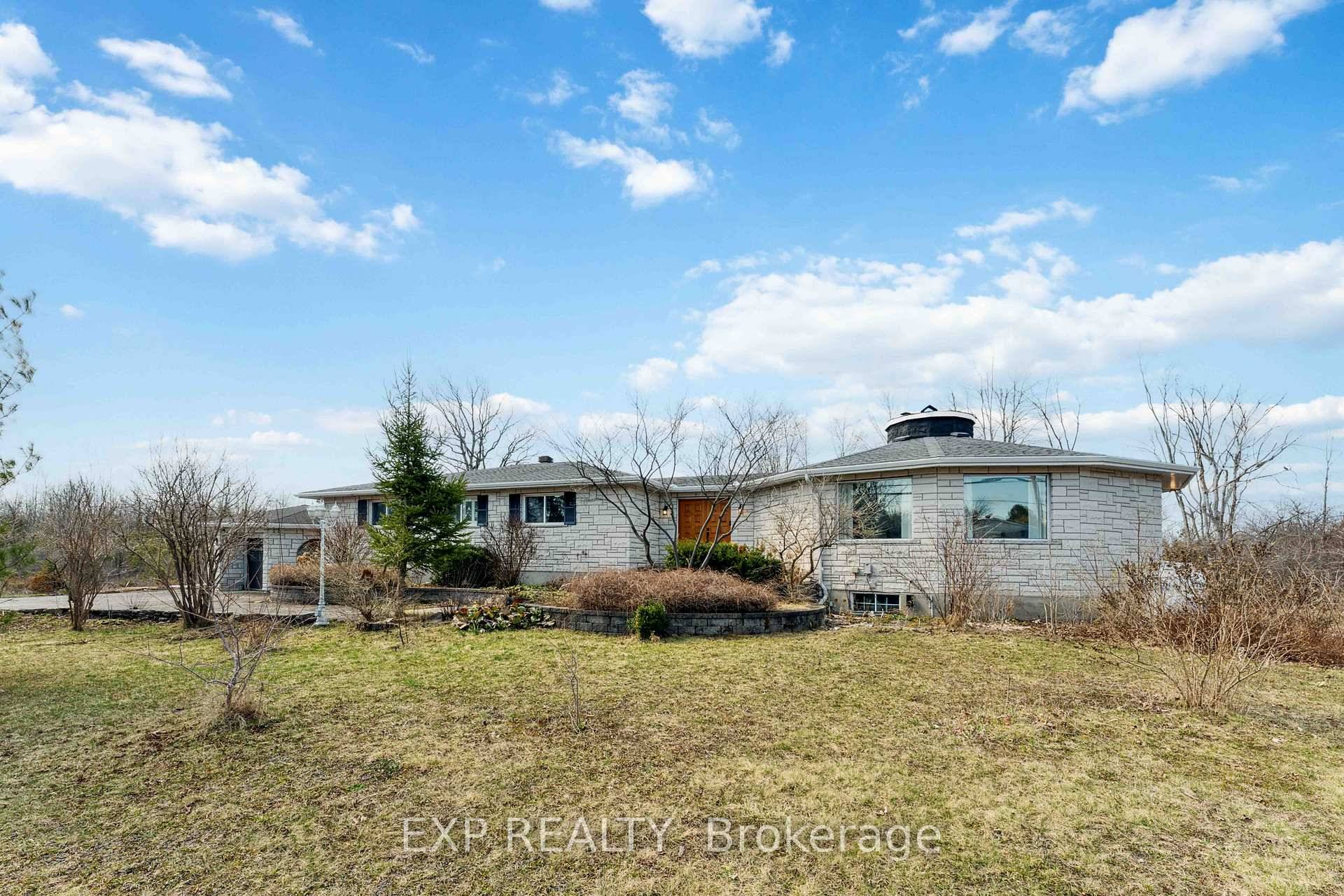 This exceptional custom designed bungalow situated on Bank Street showcases high end finishes and remarkable versatility, all set on a beautifully landscaped private acre.