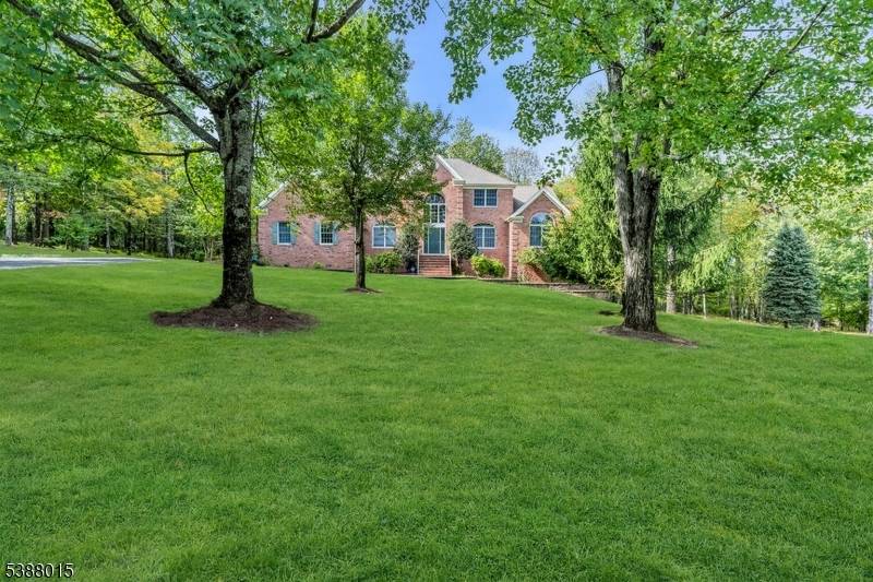 Welcome to this beautifully updated brick front colonial set atop the scenic Sourland Mountains.