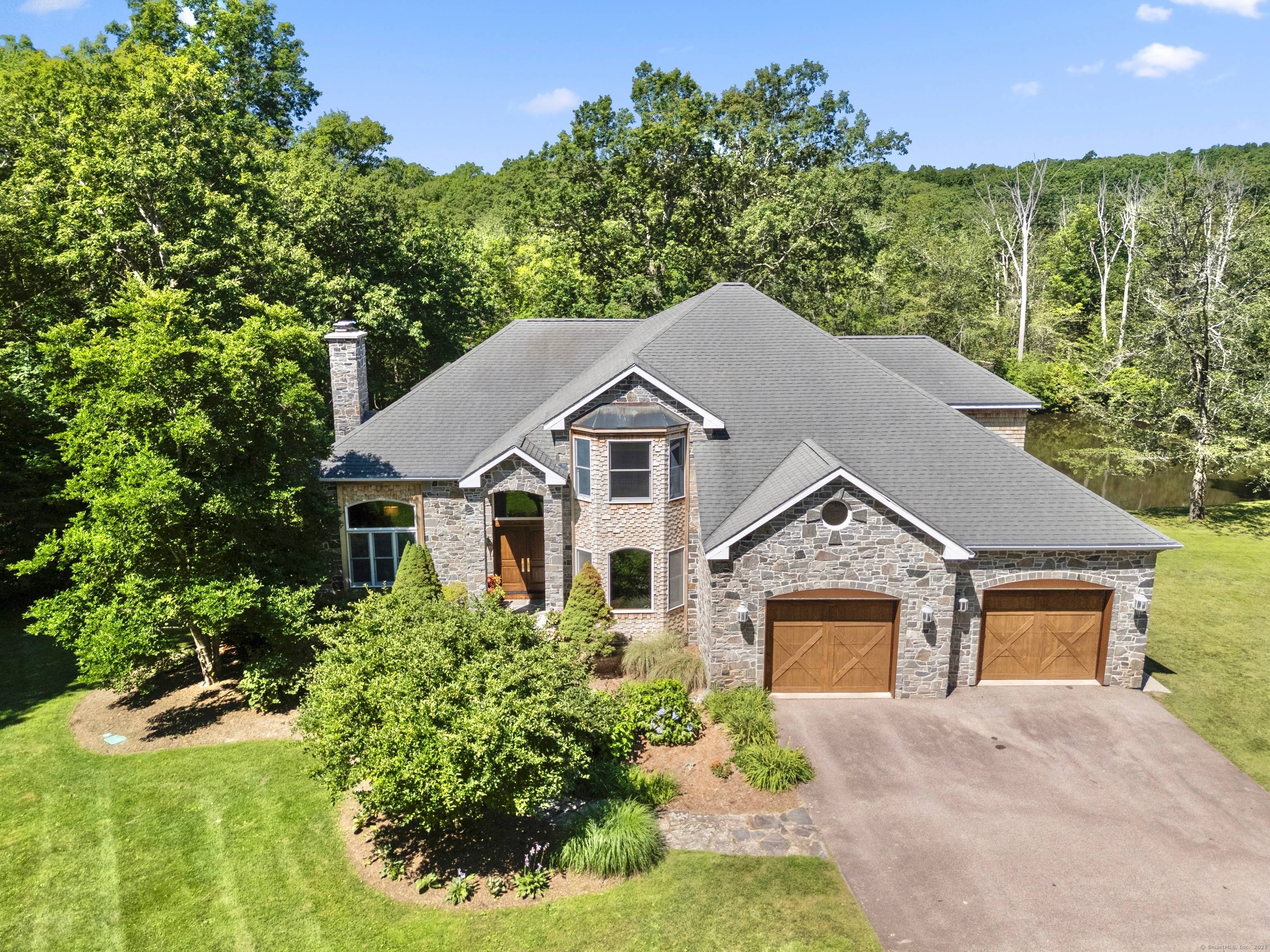 Welcome to Dolce Vita, a stone shingle craftsman prominently sited overlooking the Eight Mile River.