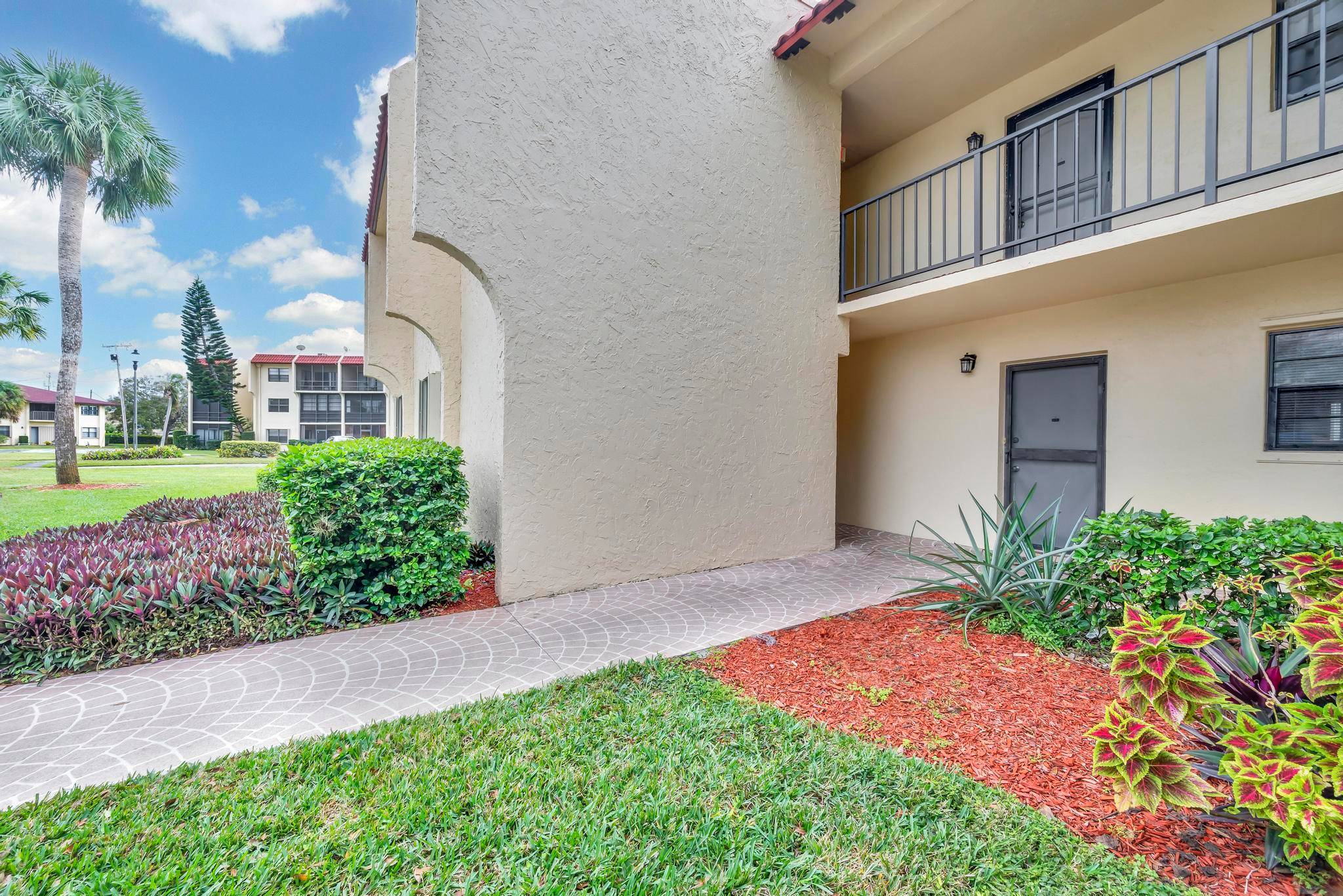 Discover serene living in this charming first floor condo, boasting a strategic corner location with extra privacy and security.